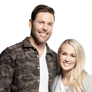 Mike Fisher and wife Carrie Underwood hug and smile at camera