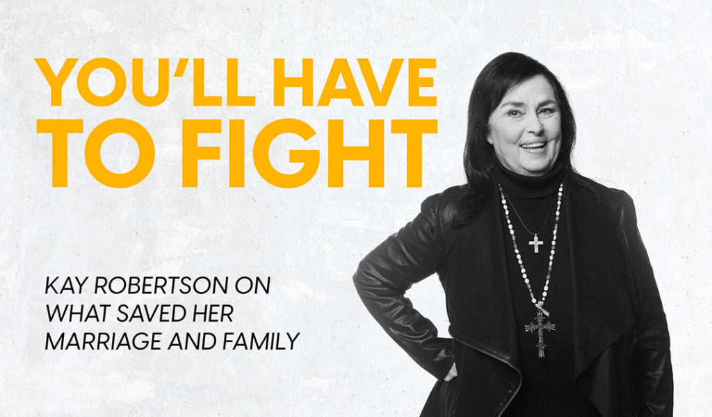 Kay Robertson smiling while standing with her hand on her hips.