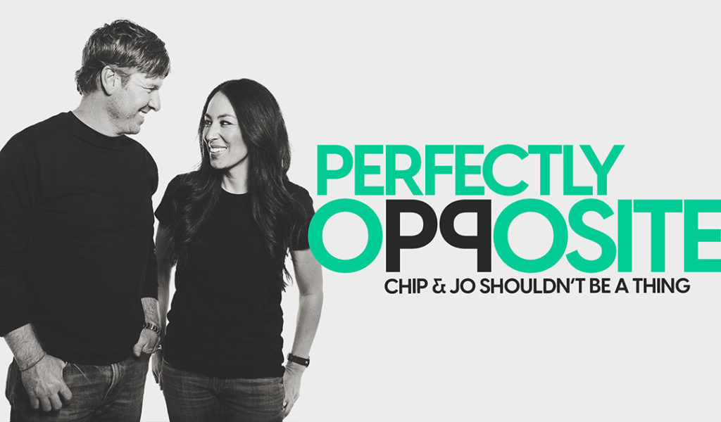 A black and white photos Chip and Joanna Gaines standing and smiling at one another.