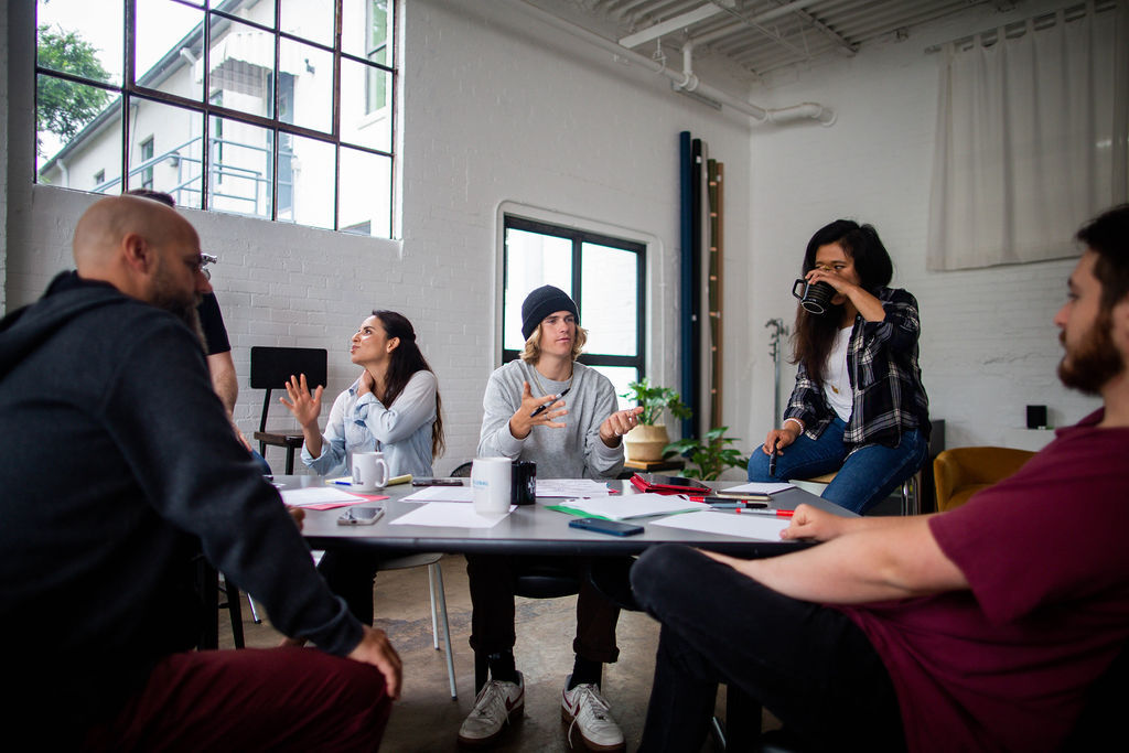 Group of people gathering around the table