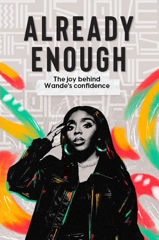 Wande standing and running her hand through her hair.