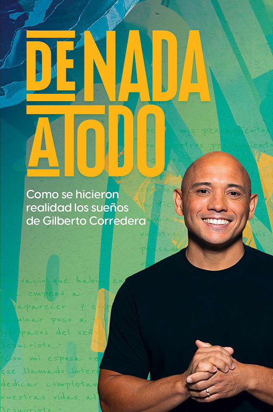 Gilberto Corredera smiling with hands clasped.